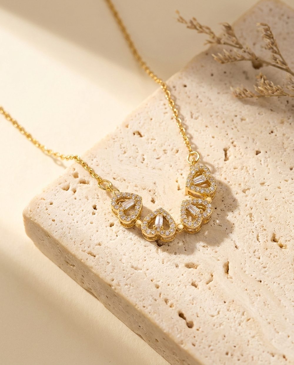 Gold four leaf clover necklace worn on the collarbone